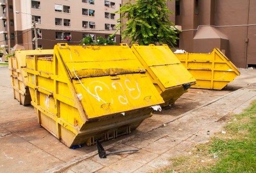 Front view of a skip and delivery truck near a street, upper banner image for complaints procedure