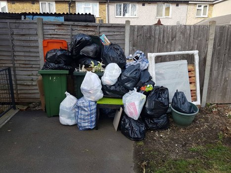 Front view of a skip on a Rotherhithe street representing skip hire services