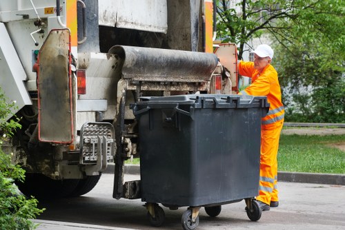 Professional loading waste into a skip in Rotherhithe.